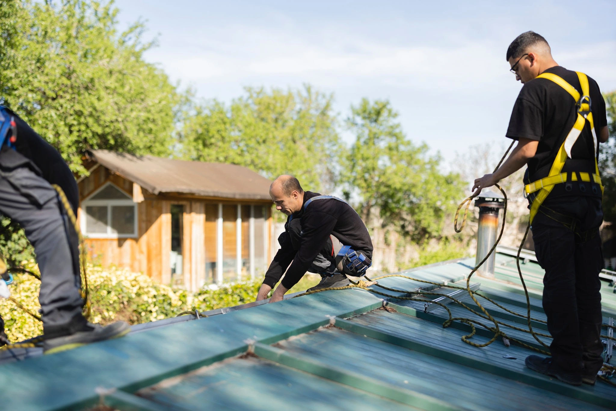 Professional roof restoration team working on a northern suburbs home, showing the quality workmanship and safety measures