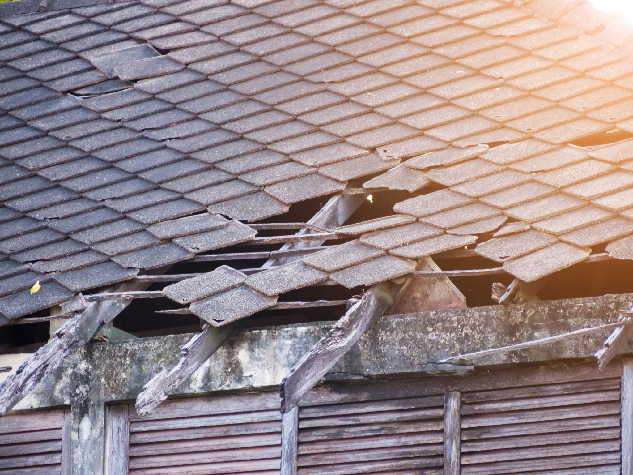 Damaged roof tiles after storm with Melbourne suburban home in background